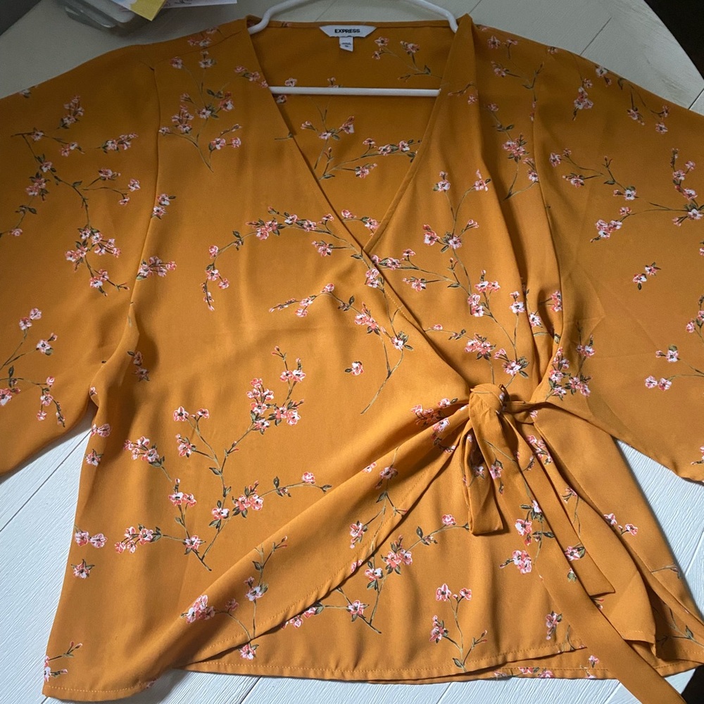 Express wrap top with floral detail. Size medium.
